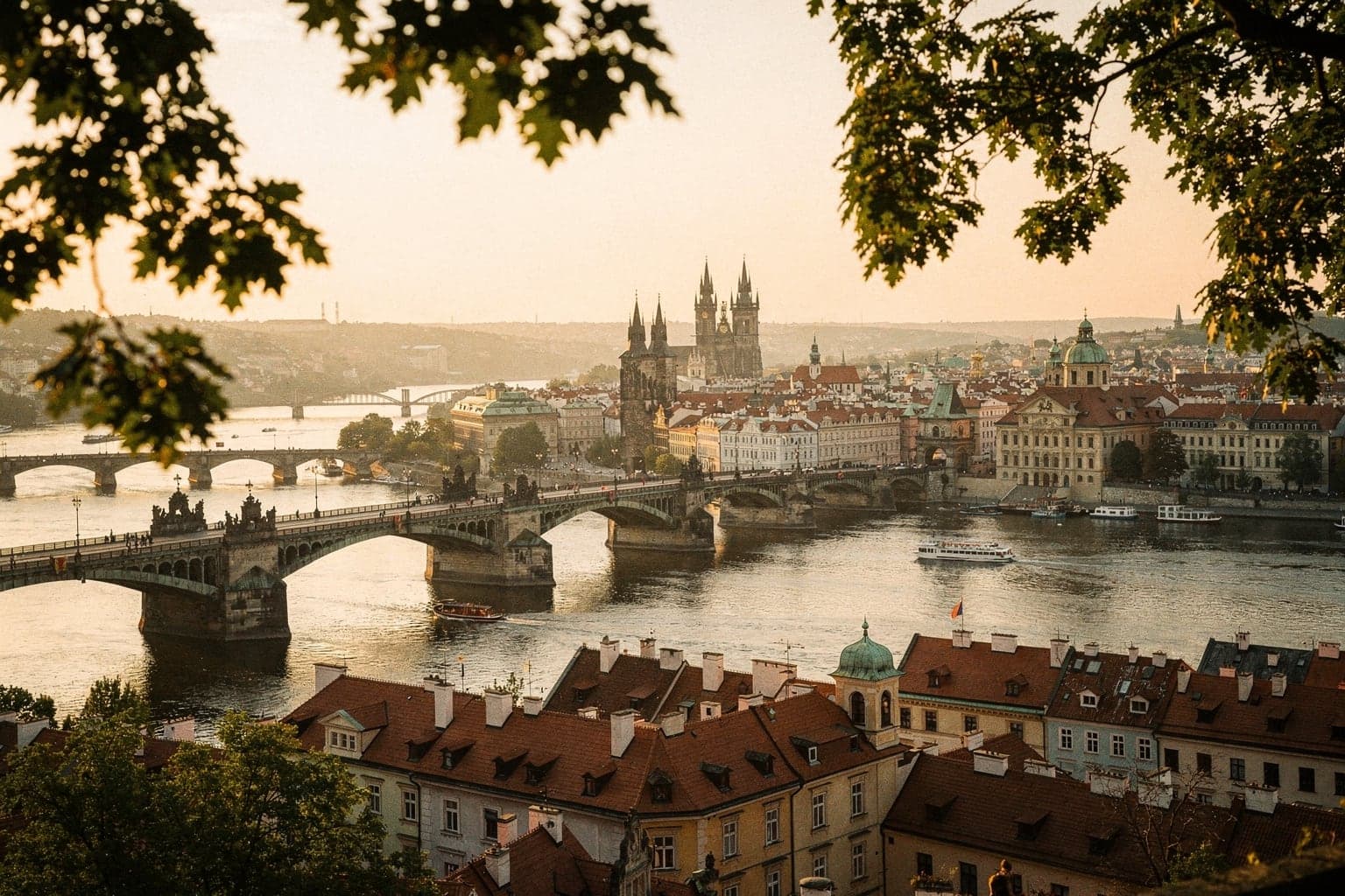 The Vltava's bridges and the Old Town's spires seen from Letná park on a summer evening